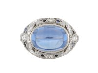 Cabochon Ceylon sapphire and diamond cluster ring, circa 1920.