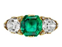Victorian Colombian emerald and diamond carved three stone ring, English, circa 1890.