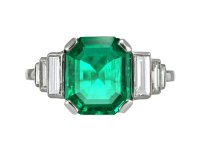 Art Deco Colombian emerald and diamond flanked solitaire ring, circa 1925.