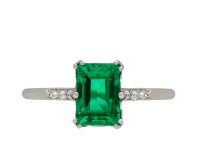 Colombian emerald and diamond flanked solitaire ring, circa 1920. Hatton Garden