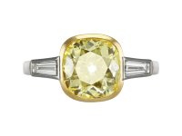 Fancy intense yellow diamond flanked solitaire ring, circa 1950.
