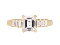 Emerald cut diamond flanked solitaire ring, circa 1970. Hatton Garden