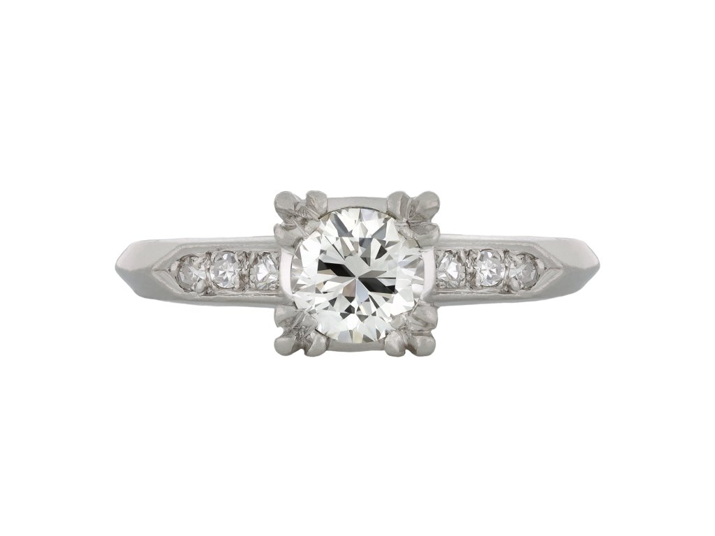 Flanked solitaire diamond ring, American, circa 1950. 