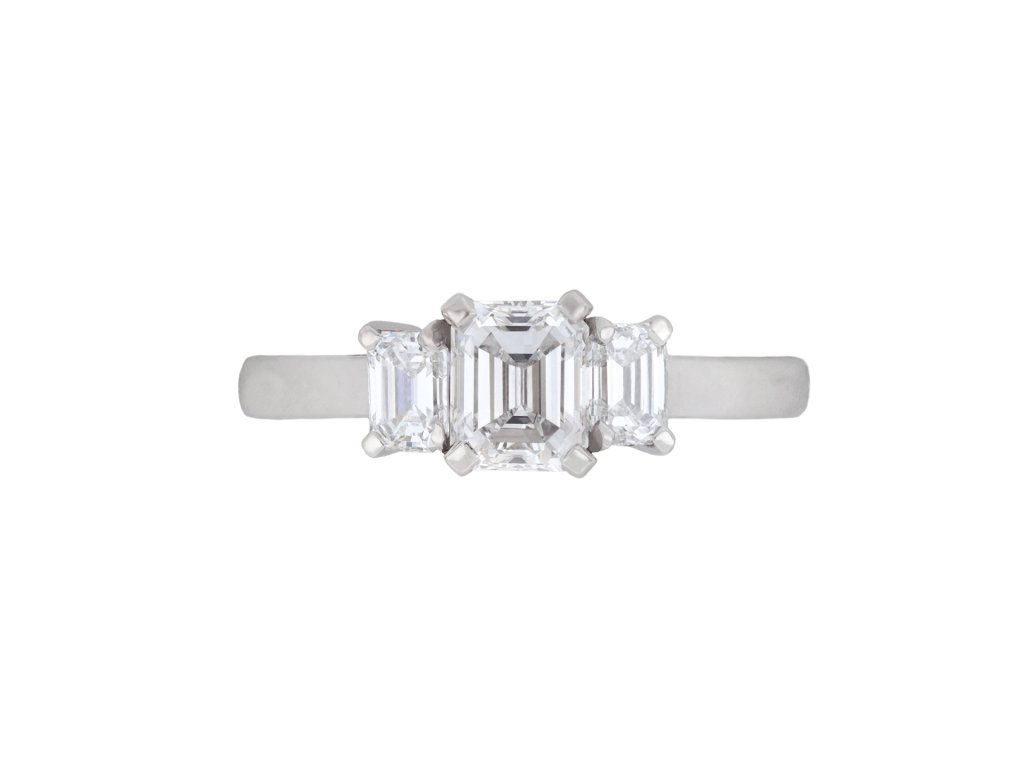 Emerald cut diamond flanked solitaire ring, circa 1950. 