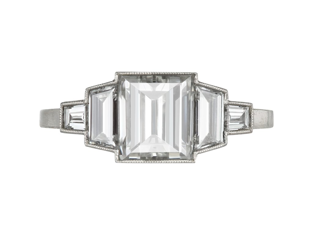 Art Deco step cut diamond flanked solitaire ring, circa 1925. 