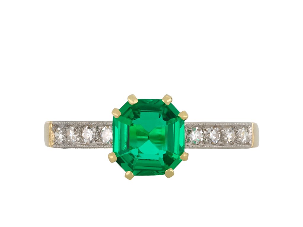 Colombian emerald diamond flanked solitaire ring hatton garden