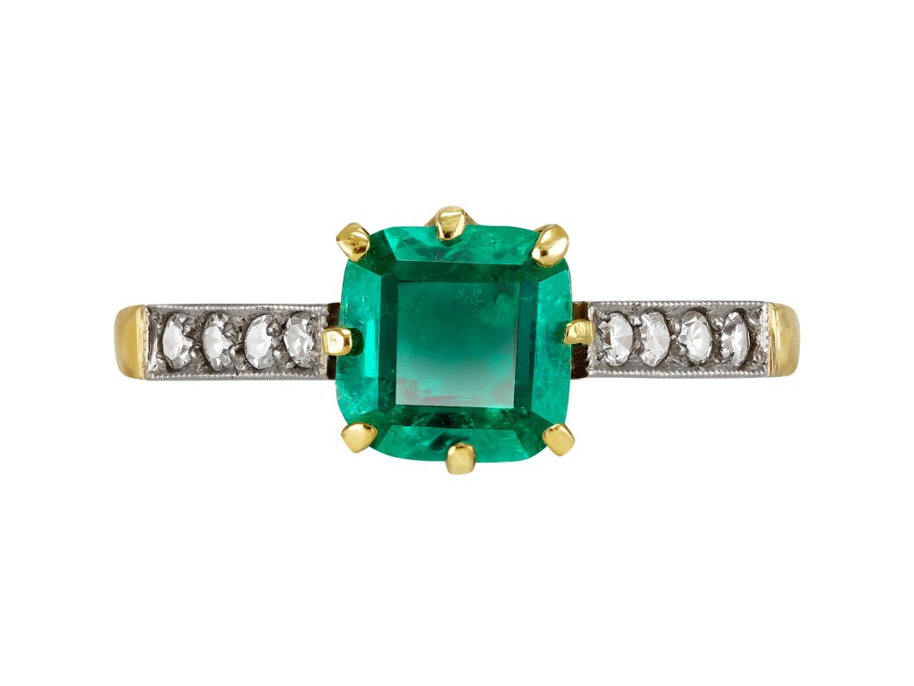 Colombian Emerald and diamond flanked solitaire ring, circa 1915.
