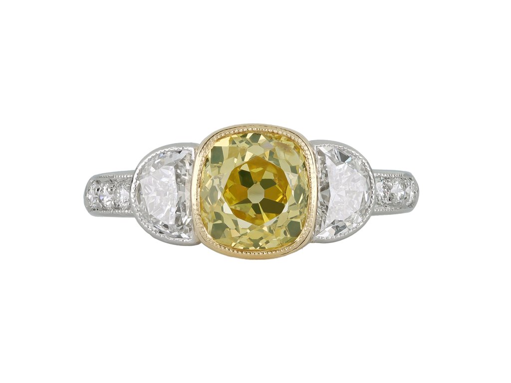 Fancy yellow diamond flanked solitaire ring, circa 1950.