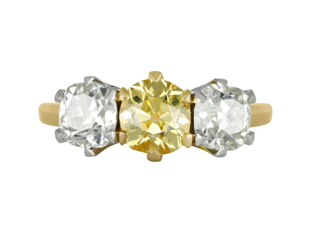 Fancy intense yellow diamond three stone ring, English, circa 1910. 