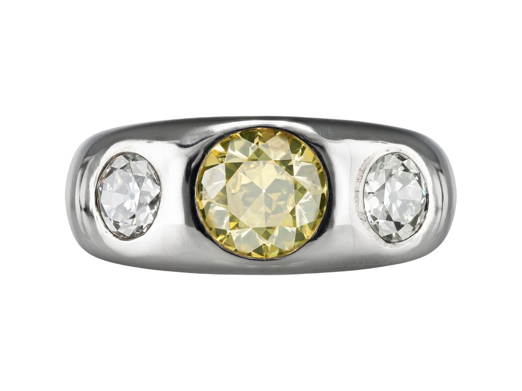 Fancy intense yellow diamond three stone gypsy ring, circa 1950.