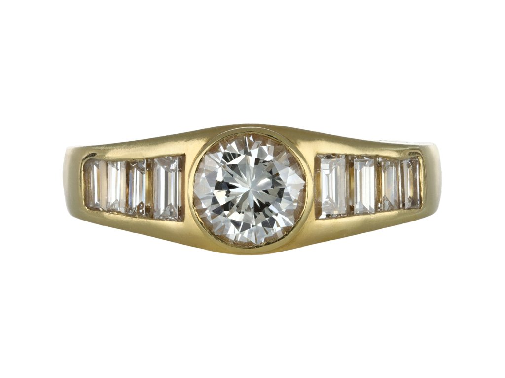 Diamond flanked solitaire ring, circa 1970.
