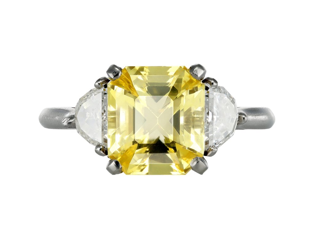 Yellow Ceylon sapphire and diamond flanked solitaire ring. 