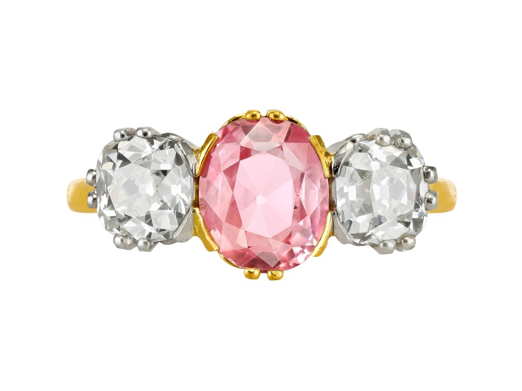 Padparadscha Ceylon sapphire and diamond three stone ring, circa 1910.