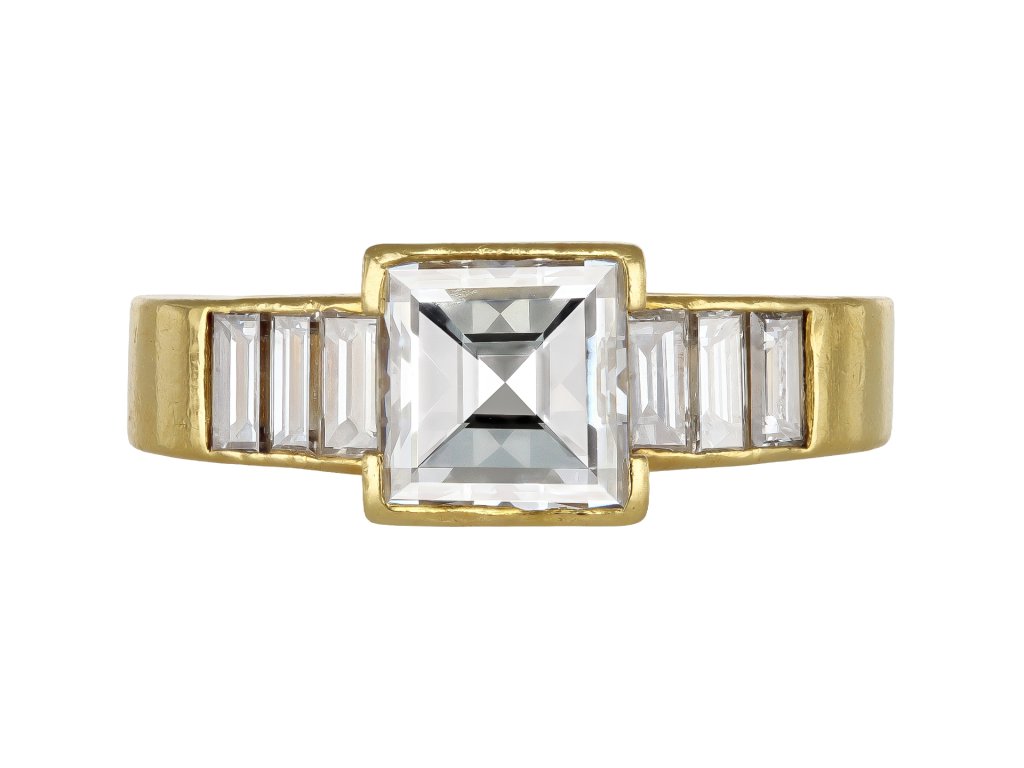 Square step cut flanked solitaire diamond ring, English, 1987.
