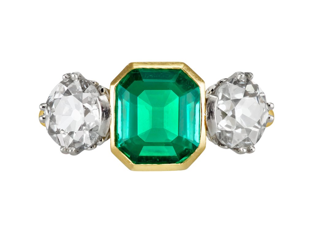 Colombian emerald and diamond flanked solitaire ring