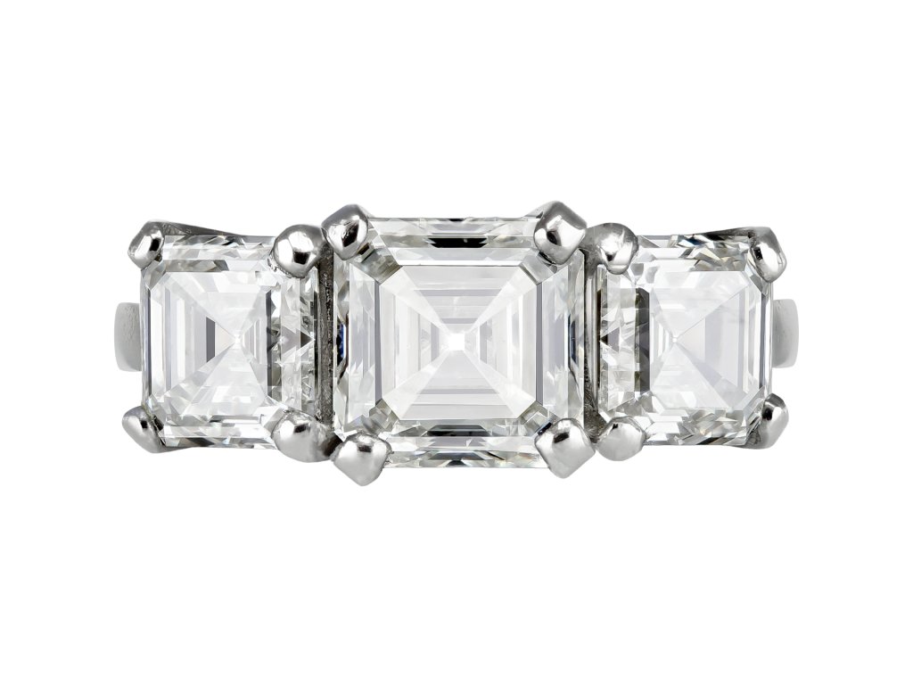 Step cut diamond three stone ring.