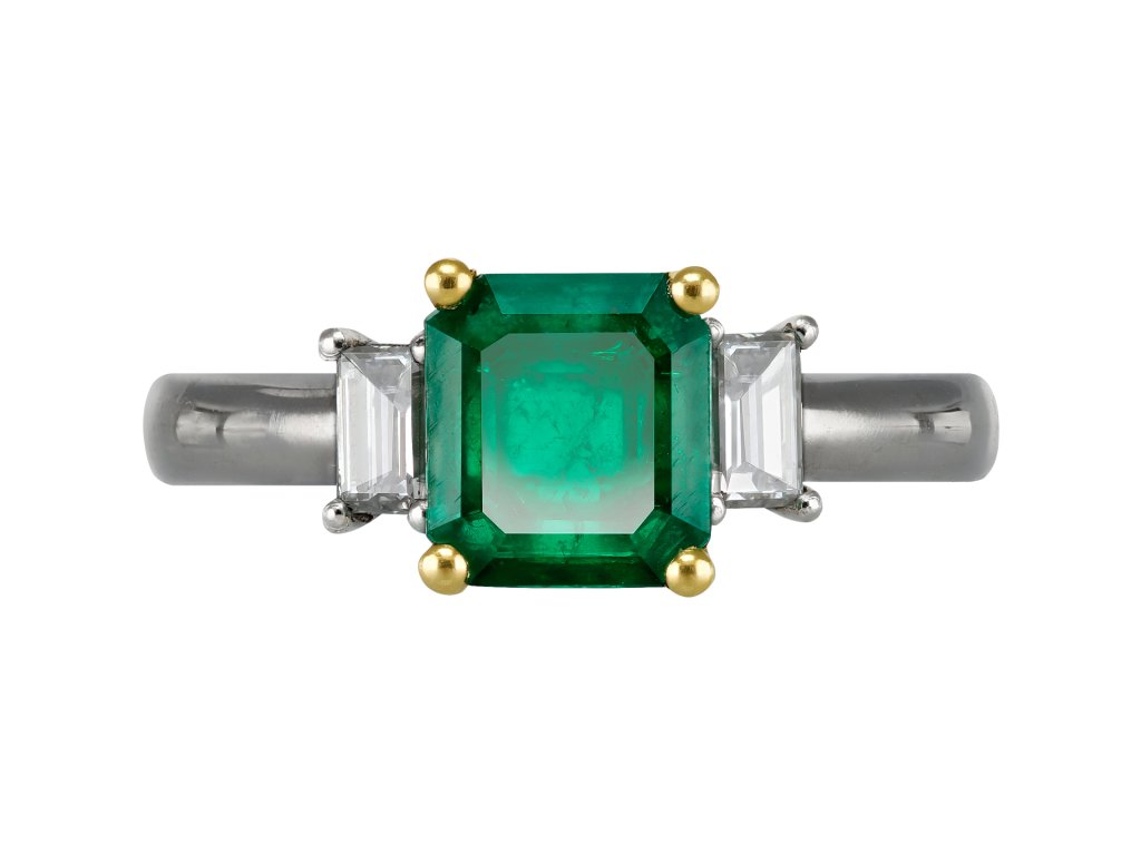 Colombian Emerald and diamond flanked solitaire ring. 