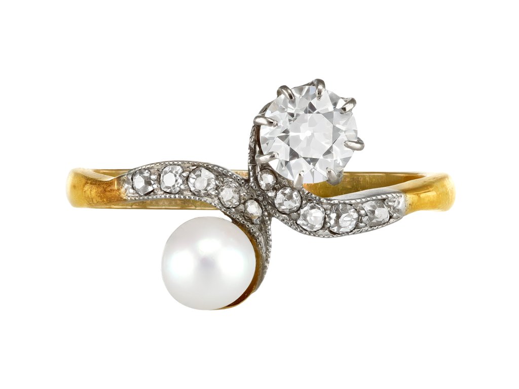 Natural pearl and diamond crossover ring, circa 1910. 