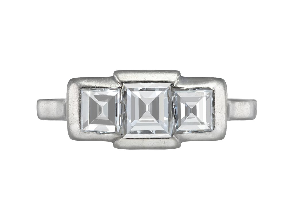 Step cut diamond three stone ring, French, early 20th Century. 
