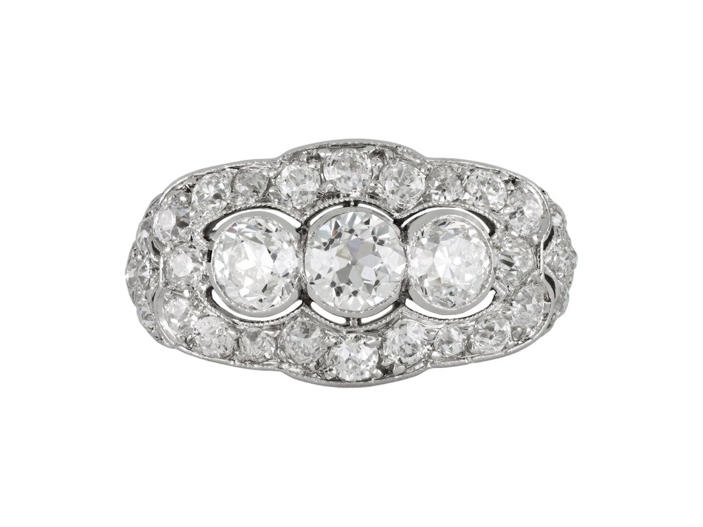 Three stone diamond cluster ring, circa 1920. 