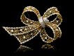 Vintage ruby and diamond bow brooch, circa 1960.