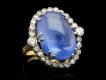 Cabochon Ceylon sapphire and diamond coronet cluster ring, circa 1920.