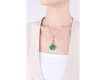 Carved emerald and diamond pendant, circa 1925. 