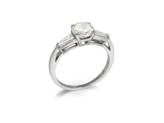 Diamond flanked solitaire ring, American, circa 1950.