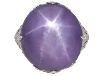 Mauve star sapphire and diamond cluster ring, circa 1920. 