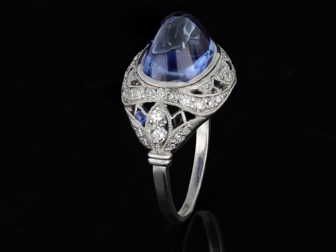 Cabochon Ceylon sapphire and diamond cluster ring, circa 1920.