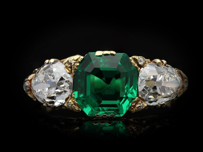 Antique emerald and diamond carved three stone ring hatton garden