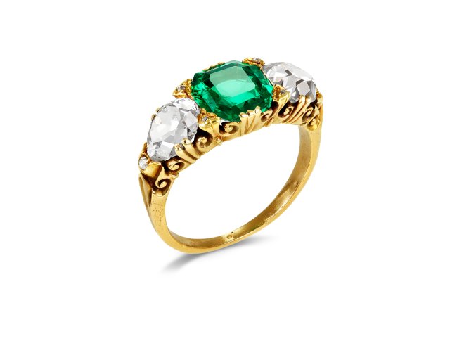 Victorian Colombian emerald and diamond carved three stone ring, English, circa 1890.