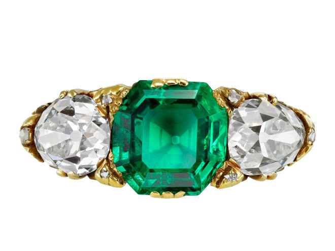 Victorian Colombian emerald and diamond carved three stone ring, English, circa 1890.