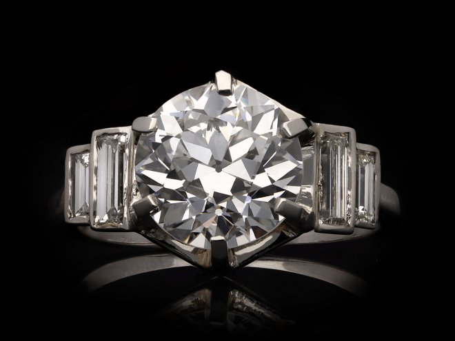 Solitaire diamond engagement ring with diamond set shoulders, French, circa 1930. Hatton Garden