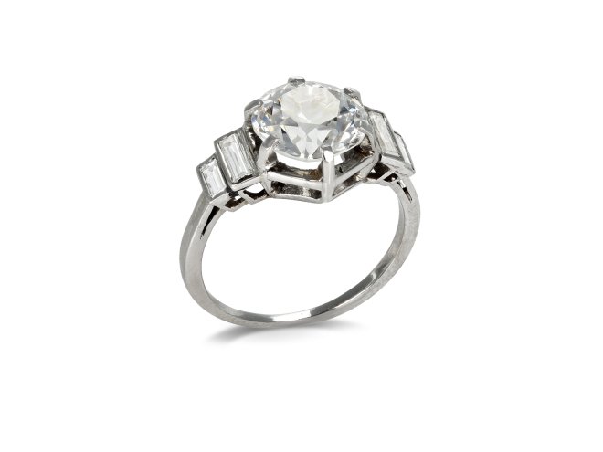 Solitaire diamond engagement ring with diamond set shoulders, French, circa 1930.