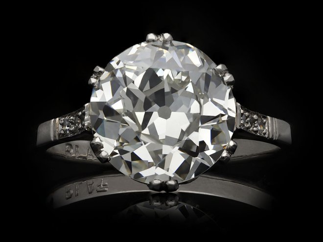 Old cut diamond flanked solitaire ring, English, circa 1920. Hatton Garden
