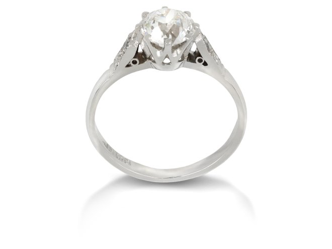 Old cut diamond flanked solitaire ring, English, circa 1935.
