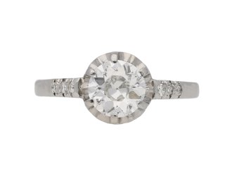 Diamond flanked solitaire engagement ring, circa 1920.