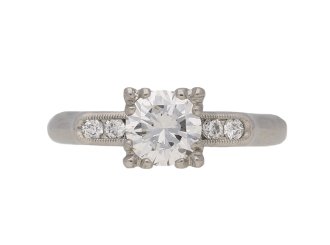 Diamond flanked solitaire engagement ring, American, circa 1950.