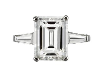 4.02 carat emerald cut diamond flanked solitaire ring, circa 1960.