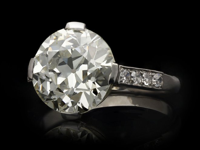 Diamond flanked solitaire ring, French, circa 1950. Hatton Garden