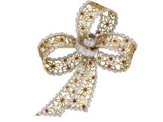 Vintage ruby and diamond bow brooch, circa 1960.