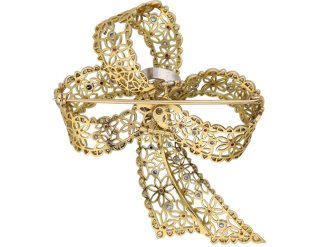 Vintage ruby and diamond bow brooch, circa 1960.