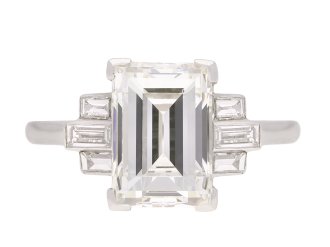 Art Deco flanked solitaire step cut diamond ring, circa 1925. Hatton Garden