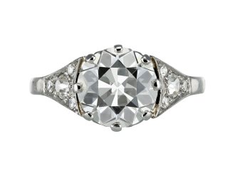 Edwardian diamond flanked solitaire ring, circa 1910. 