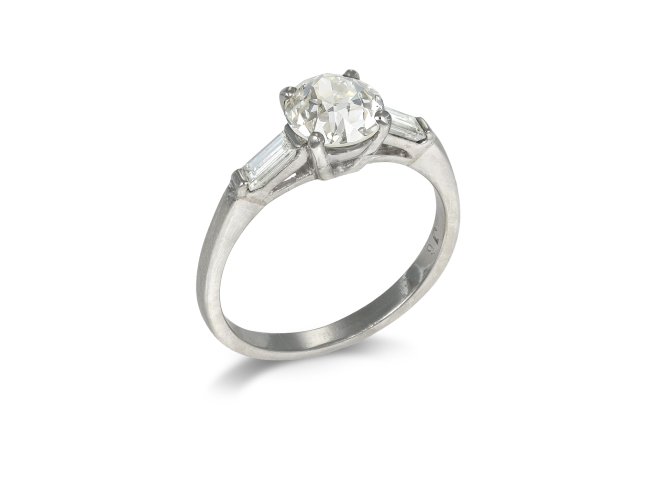 Vintage flanked solitaire diamond ring, circa 1950.