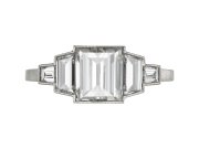 Art Deco step cut diamond flanked solitaire ring, circa 1925. 