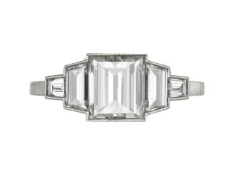 Art Deco step-cut diamond flanked solitaire ring, circa 1925. 