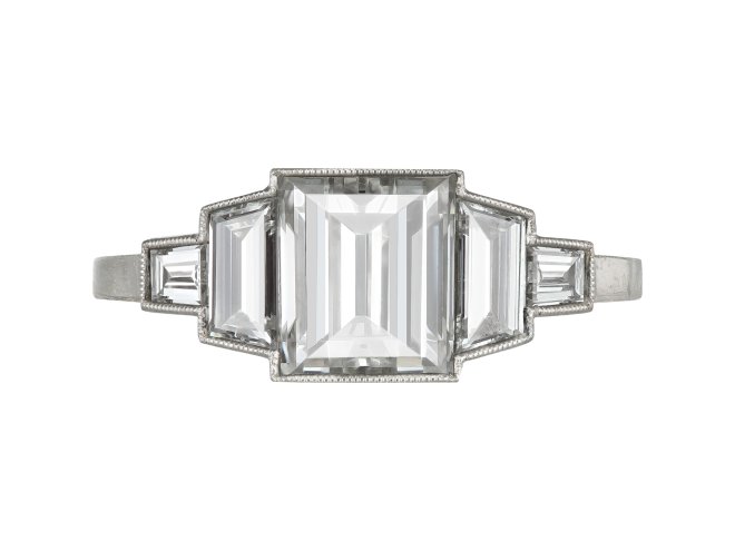 Art Deco step cut diamond flanked solitaire ring, circa 1925. 