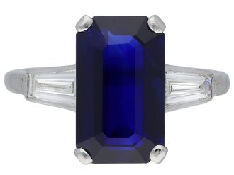 Ceylon sapphire and diamond flanked solitaire ring.